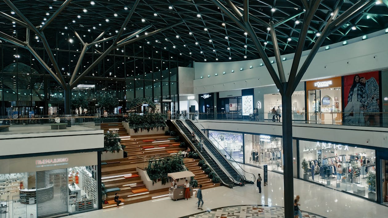 Modern spacious shopping mall interior similar to Stonebriar Centre in Frisco Texas with shops and greenery