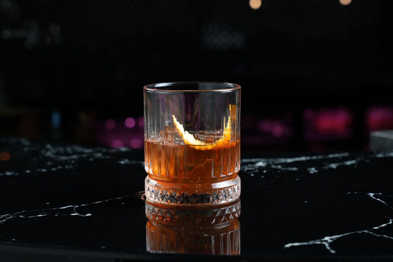 Old fashioned whiskey cocktail on a bar top, a staple at cocktail lounges in Frisco TX