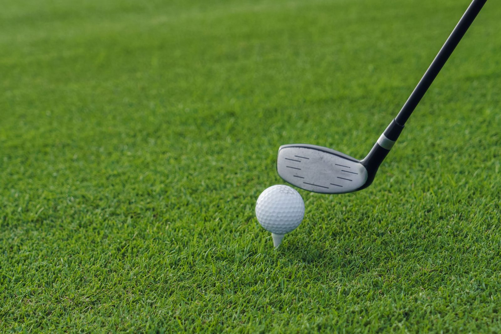 Golfer teeing off on a Frisco TX golf course fairway