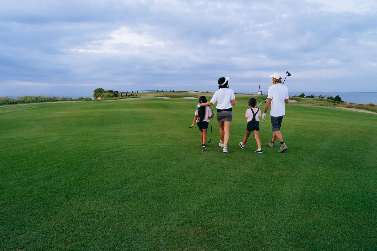 Family playing a beginner-friendly par-3 golf course together