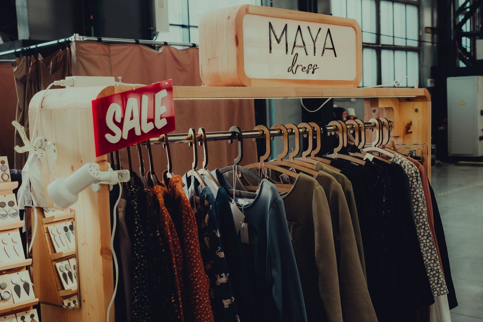 Clothing sale rack with discount price tags at an outlet store