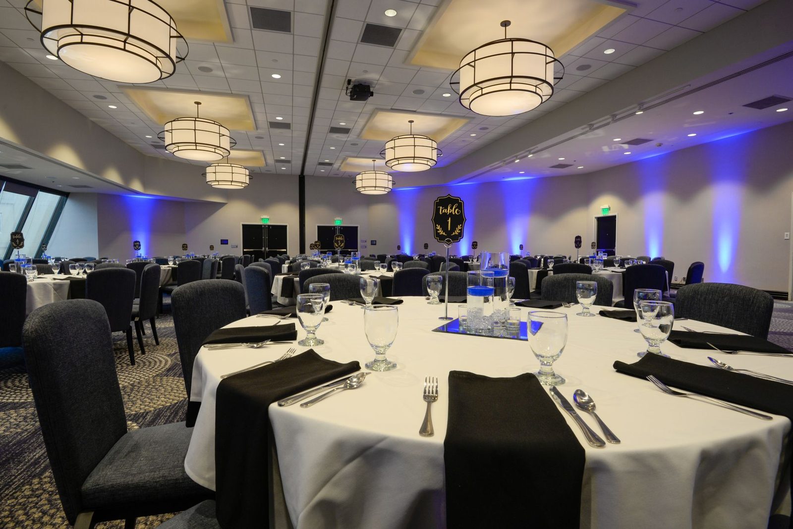 Hotel ballroom set with round banquet tables for a Frisco TX corporate gala