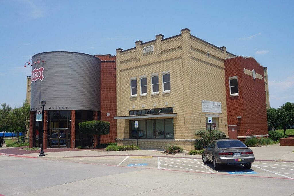 Brick Frisco Heritage Museum building with a silo-shaped entrance and a small parking lot