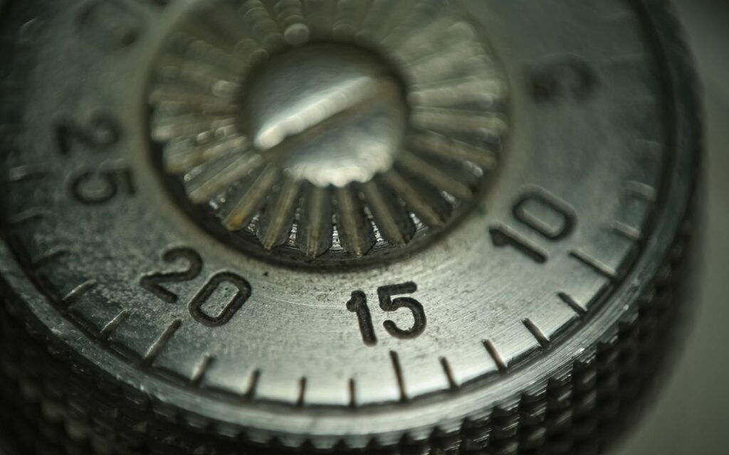 Close-up of a metal combination lock dial numbered 10 to 25