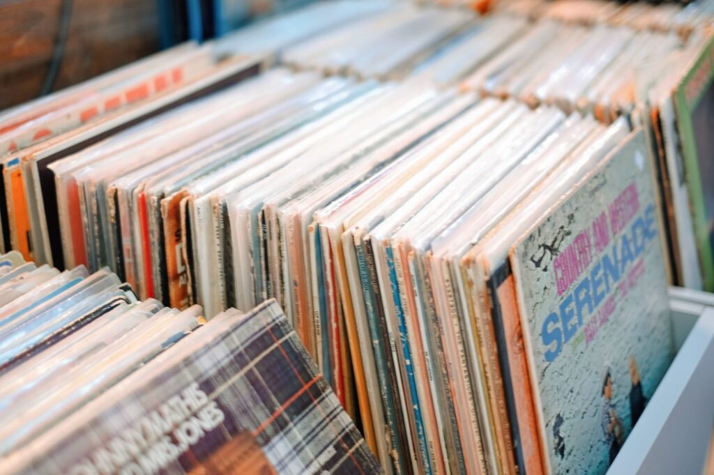 Close-up of used vinyl records flipped forward in a store bin