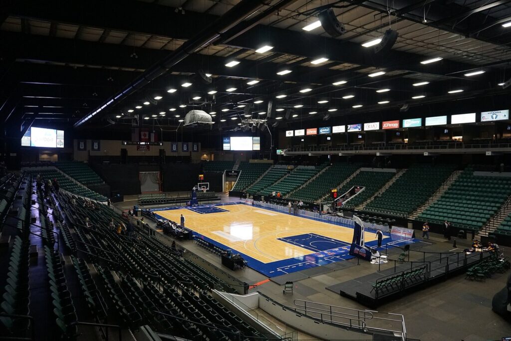 Comerica Center arena in Frisco with its seating bowl around an empty basketball court