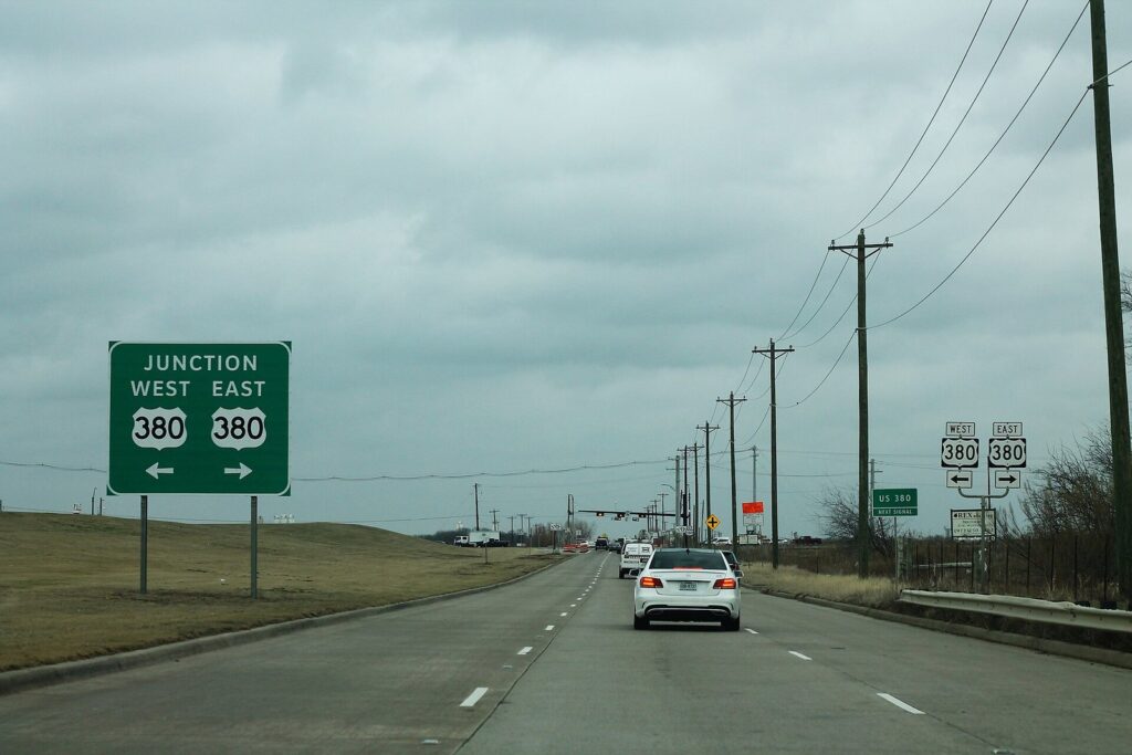 Dallas North Tollway end sign at the US 380 junction under a cloudy sky