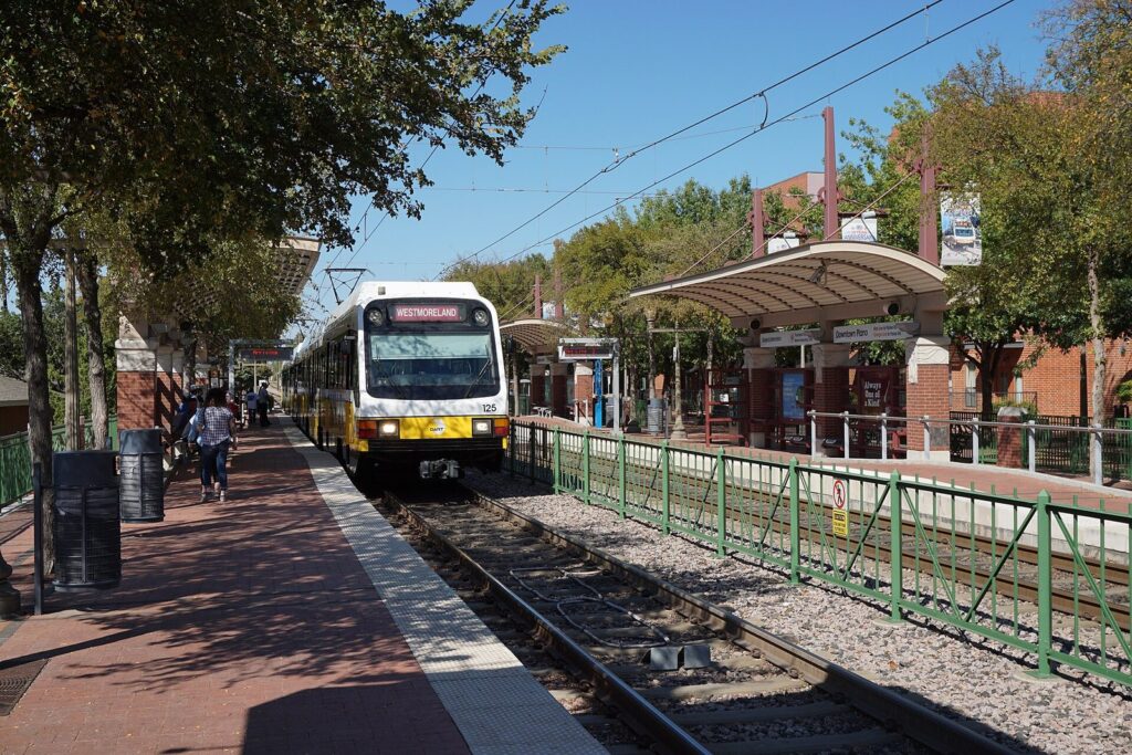 DART light rail train stopped at the Downtown Plano station platform