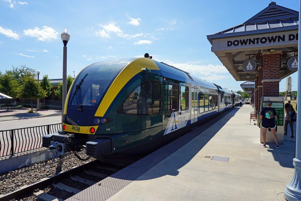 DCTA A-train commuter rail car stopped at the Downtown Denton Transit Center platform