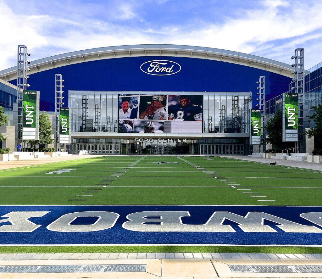 Ford Center at The Star with a blue Ford sign above a Cowboys-painted turf field