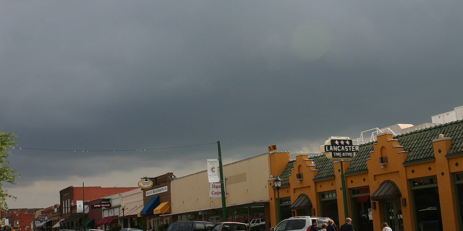 Historic Main Street in Grapevine, the closest cluster of wineries near Frisco TX, under a stormy sky