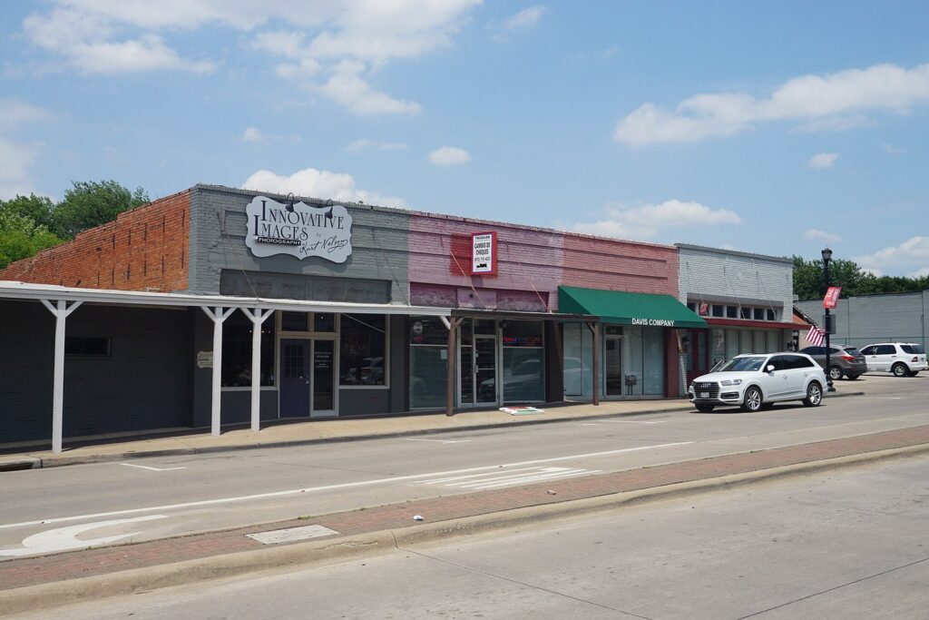 Low brick storefronts with metal awnings along Main Street in Frisco's Rail District
