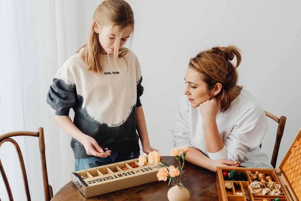 Mother and daughter solving puzzles together, a warm-up for family escape rooms in Frisco TX
