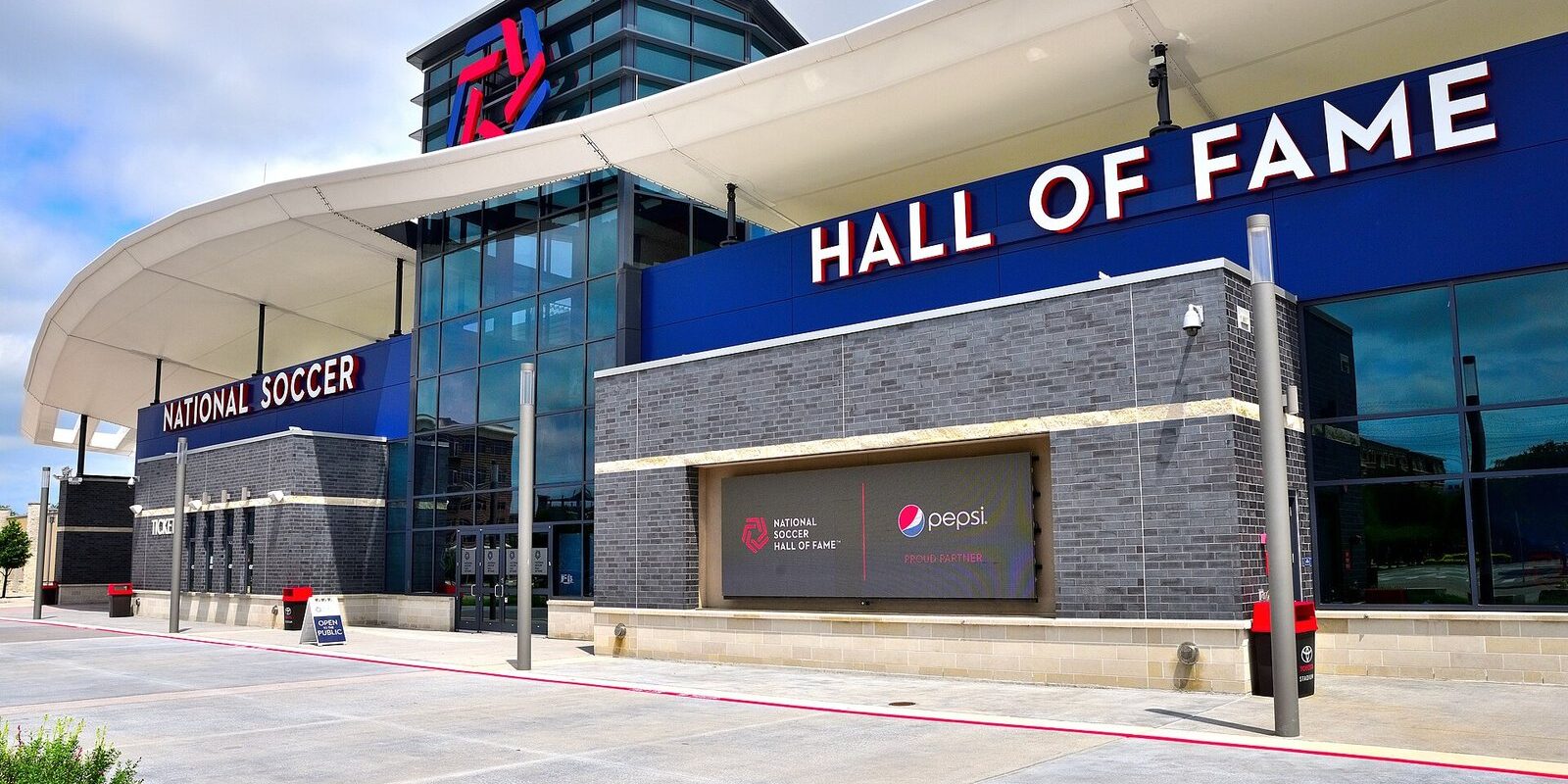 National Soccer Hall of Fame in Frisco entrance with its curved white canopy and blue Hall of Fame sign