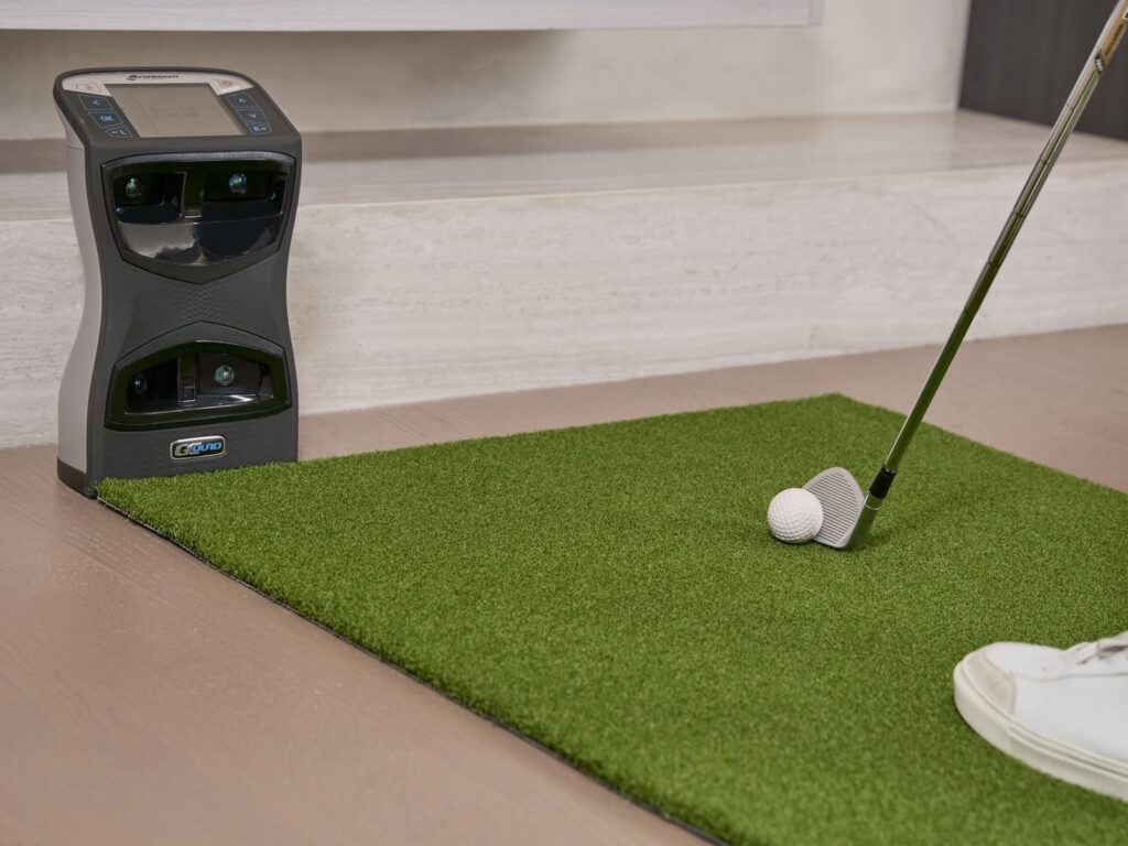 Portable launch monitor behind a teed ball, the kind of data tool used in golf lessons in Frisco TX