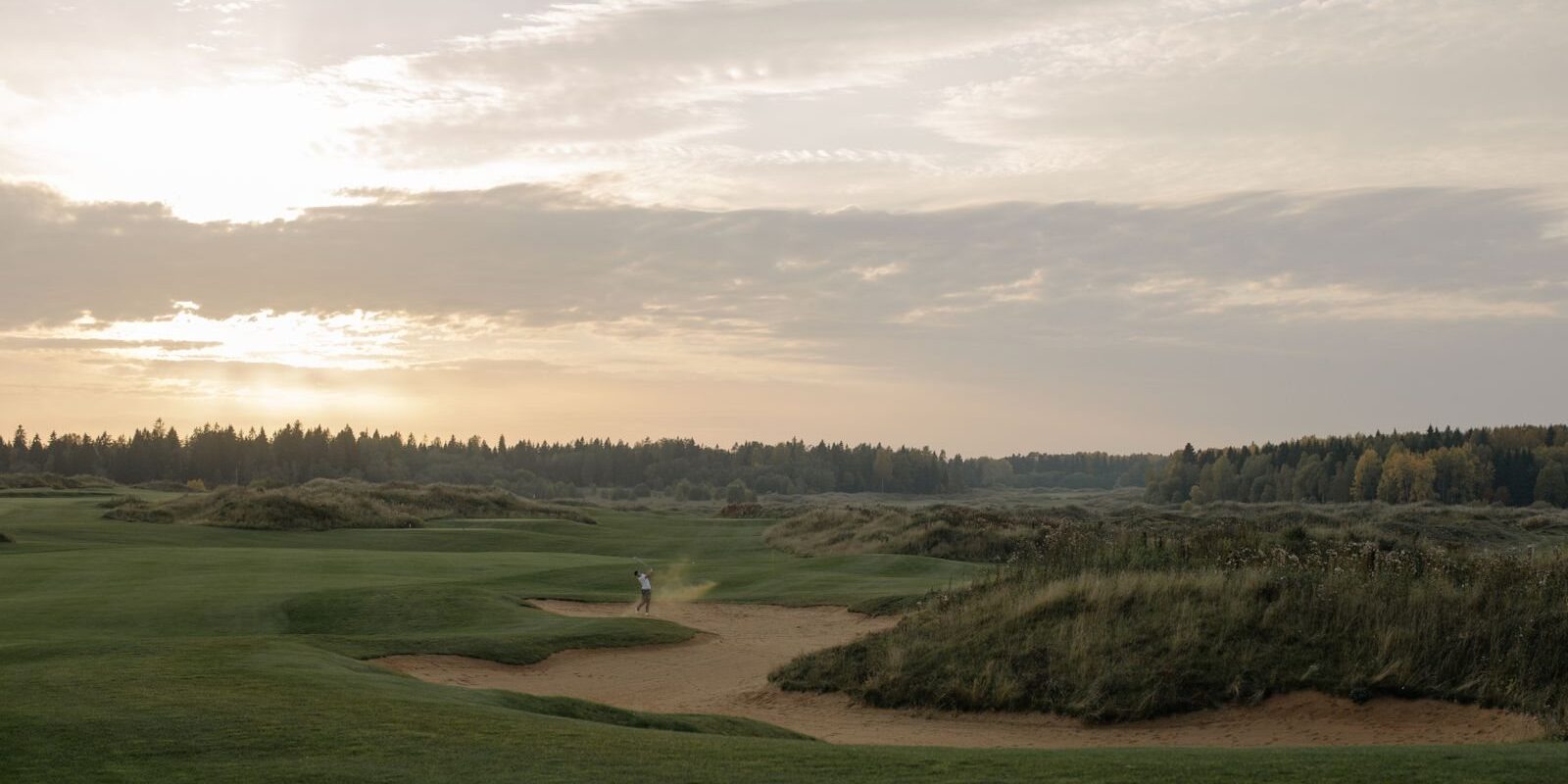 Sunrise over bunkers and native grass on an open course, ideal tee-time light for public golf in Frisco TX