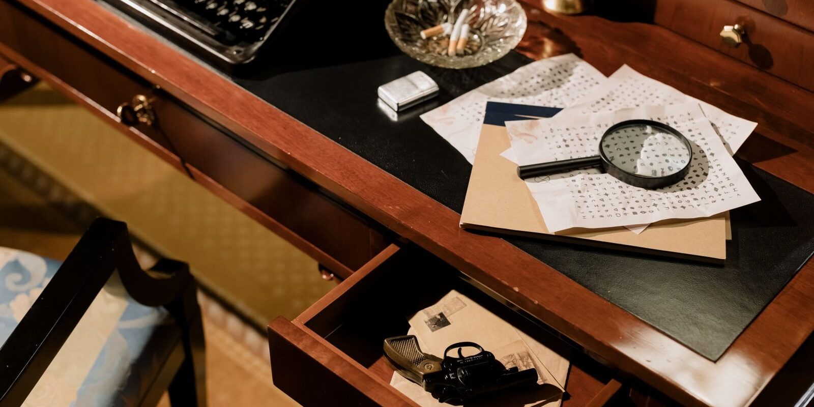 Vintage detective desk with a typewriter, magnifying glass and scattered clue papers